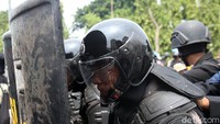 Polisi bertameng membentuk barikade untuk menghentikan massa aksi bergerak ke Istana.