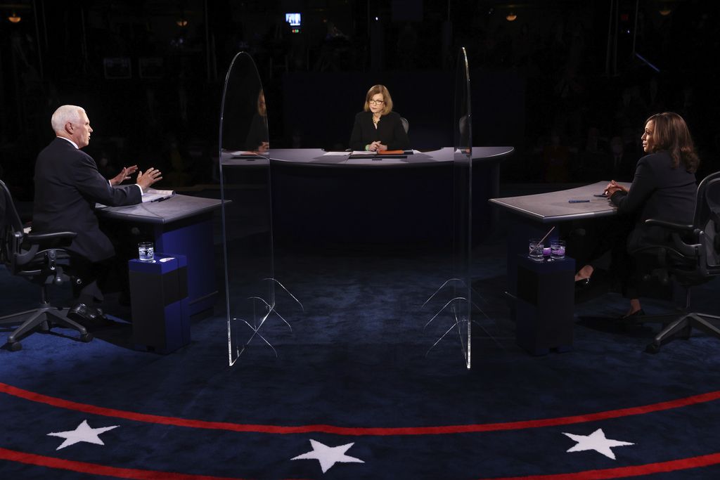 Vice President Mike Pence speaks as Democratic vice presidential candidate Sen. Kamala Harris, D-Calif., listens during the vice presidential debate Wednesday, Oct. 7, 2020, at Kingsbury Hall on the campus of the University of Utah in Salt Lake City. (Justin Sullivan/Pool via AP)