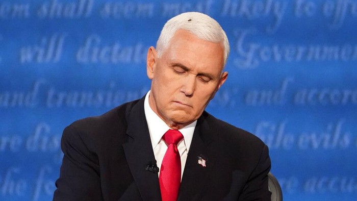 Vice President Mike Pence listens to Democratic vice presidential candidate Sen. Kamala Harris, D-Calif., during the vice presidential debate Wednesday, Oct. 7, 2020, at Kingsbury Hall on the campus of the University of Utah in Salt Lake City. (AP Photo/Julio Cortez)
