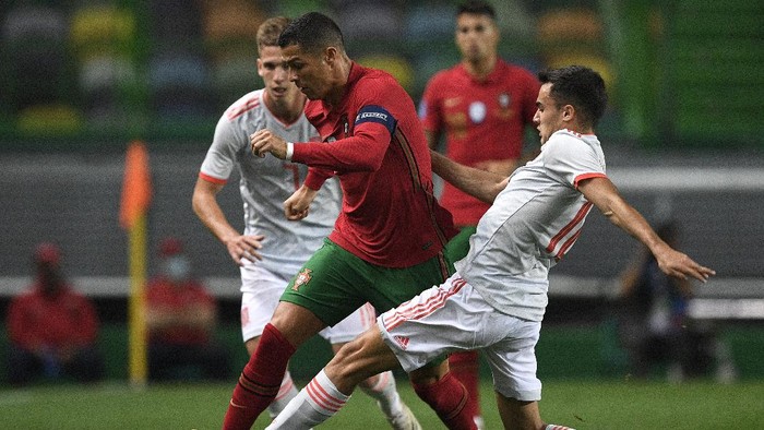 LISBON, PORTUGAL - OCTOBER 07:  Cristiano Ronaldo, Captain of Portugal is tackled by Sergio Reguilon of Spain during the international friendly match between Portugal and Spain at Estadio Jose Alvalade on October 07, 2020 in Lisbon, Portugal. (Photo by Octavio Passos/Getty Images)