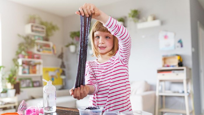 Little girl making homemade slime toy