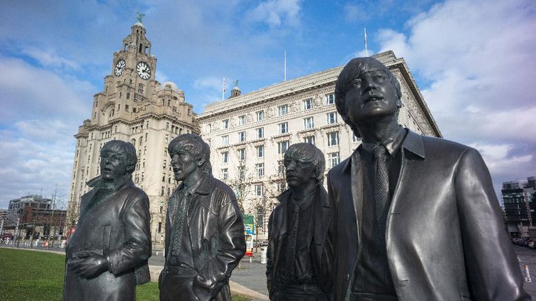 Liverpool LIVERPOOL, ENGLAND - FEBRUARY 11: The recently unveiled new statues of Paul McCartney, George Harrison, Ringo Starr and John Lennon of the Beatles stand outside the Liver Building at Liverpool Waterfront on February 11, 2016 in Liverpool, England. New research commissioned by Liverpool City Council has shown that the legacy and continued popularity of The Beatles adds GBP 81.9 million to the local economy each year and supports 2,335 jobs. (Photo by Christopher Furlong/Getty Images)
