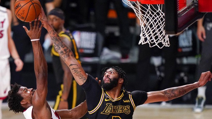 Los Angeles Lakers forward Anthony Davis, blocks a shot by Miami Heat forward Jimmy Butler during the first half in Game 5 of basketballs NBA Finals Friday, Oct. 9, 2020, in Lake Buena Vista, Fla. (AP Photo/Mark J. Terrill)