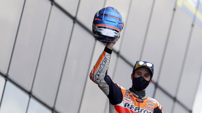 Second placed Spains rider Alex Marquez of the Repsol Honda Team celebrates with trophy on the podium after the MotoGP race of the French Motorcycle Grand Prix at the Le Mans racetrack, in Le Mans, France, Sunday, Oct. 11, 2020. (AP Photo/David Vincent)