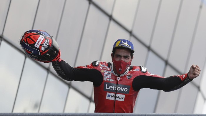 Italian rider Danilo Petrucci of the Ducati Team celebrates on the podium after winning the MotoGP race of the French Motorcycle Grand Prix at the Le Mans racetrack, in Le Mans, France, Sunday, Oct. 11, 2020. (AP Photo/David Vincent)