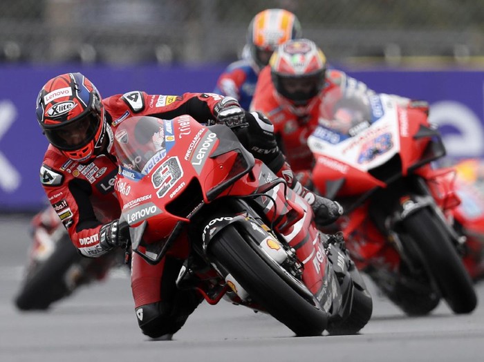 Italian rider Danilo Petrucci of the Ducati Team steers his motorcycle followed by Australian rider Jack Miller of the Pramac Racing during the MotoGP race of the French Motorcycle Grand Prix at the Le Mans racetrack, in Le Mans, France, Sunday, Oct. 11, 2020. (AP Photo/David Vincent)
