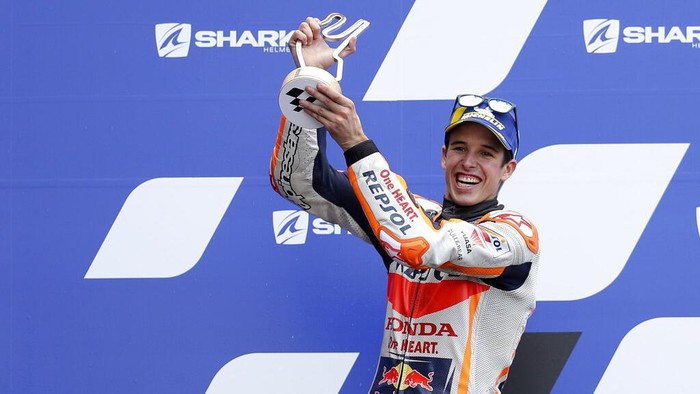 Second placed Spains rider Alex Marquez of the Repsol Honda Team celebrates with trophy on the podium after the MotoGP race of the French Motorcycle Grand Prix at the Le Mans racetrack, in Le Mans, France, Sunday, Oct. 11, 2020. (AP Photo/David Vincent)