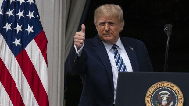 With two bandages on his hand, President Donald Trump gestures while speaking from the Blue Room Balcony of the White House to a crowd of supporters, Saturday, Oct. 10, 2020, in Washington. (AP Photo/Alex Brandon)