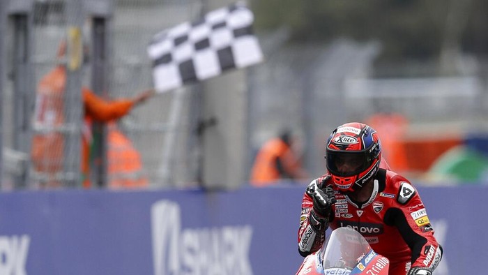 Italian rider Danilo Petrucci of the Ducati Team celebrates after winning the MotoGP race of the French Motorcycle Grand Prix at the Le Mans racetrack, in Le Mans, France, Sunday, Oct. 11, 2020. (AP Photo/David Vincent)