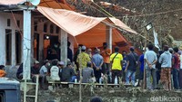 Warga sedang mengantre pembagian logistik di sekitar tenda penampungan.