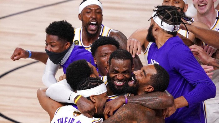Los Angeles Lakers LeBron James (23) celebrates with his teammates after the Lakers defeated the Miami Heat 106-93 in Game 6 of basketballs NBA Finals Sunday, Oct. 11, 2020, in Lake Buena Vista, Fla. (AP Photo/Mark J. Terrill)