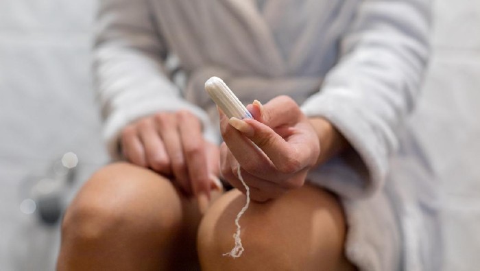 Tampon Young woman hands holding hygienic tampon