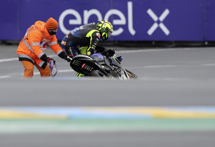 Italian rider Valentino Rossi of the Monster Energy Yamaha MotoGP after crashing during the MotoGP race of the French Motorcycle Grand Prix at the Le Mans racetrack, in Le Mans, France, Sunday, Oct. 11, 2020. (AP Photo/David Vincent)