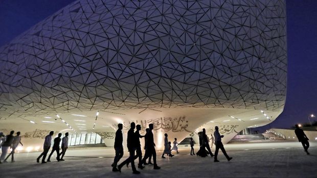 In this Sunday, May 12, 2019 photo, people leave a mosque to have their evening meal, Iftar, during the holy month of Ramadan, at the Qatar Faculty of Islamic Studies in Doha, Qatar. Designed by Mangera Yvars Architects, the building's shape is conceptually based on the historical 