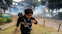 Massa tampak berlarian ke segala arah saat polisi menembakkan gas air mata.