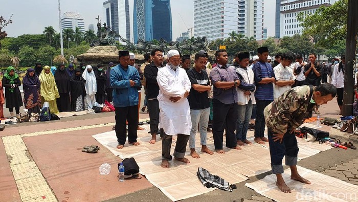 Massa PA 212 dkk melaksanakan Salat Zuhur di Jalan Medan Merdeka Barat, Jakarta