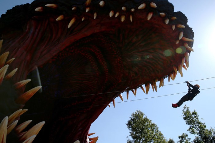 AWAJI, JAPAN - OCTOBER 11: Visitors line up to buy tickets for  'National Awaji Island Institute of Godzilla Disaster' featuring Godzilla's life-size replica at the Nijigen no Mori theme park on Awaji Island on October 11, 2020 in Awajishima, Hyogo Prefecture, Japan. 'National Awaji Island Institute of Godzilla Disaster' featuring 'life-size' Godzilla replica zipline is the latest addition to this park featuring attractions themed around Japanese anime works. (Photo by Buddhika Weerasinghe/Getty Images)