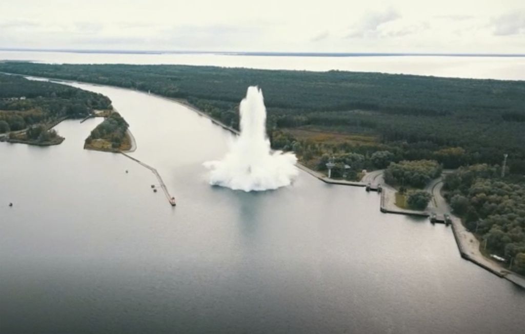 In this frame grab from a video made available Wednesday, Oct. 14, 2020, an explosion is seen in a waterway leading to the port of Szczecin, from Swinoujscie, Poland. A British World War II bomb exploded while being made safe underwater by navy demolition specialists in northwestern Poland on Tuesday. (Poznan Technical University via AP)