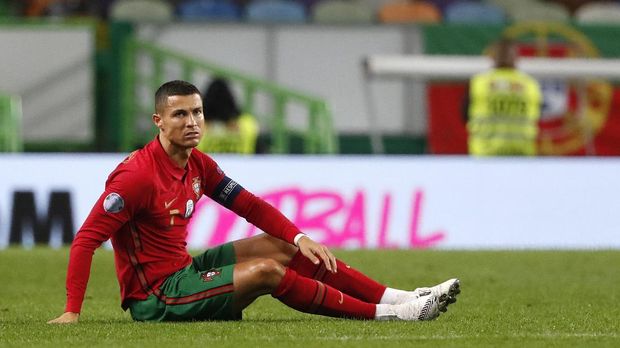 FILE - In this Wednesday, Oct. 7, 2020 file photo Portugal's Cristiano Ronaldo, right, sits on the pitch during the international friendly soccer match between Portugal and Spain at the Jose Alvalade stadium in Lisbon. The Portuguese soccer federation says Cristiano Ronaldo has tested positive for the coronavirus. The federation says Ronaldo is doing well and has no symptoms. He has been dropped from the country's Nations League match against Sweden on Wednesday. (AP Photo/Armando Franca, File)