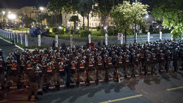 Pro-democracy protesters push Thai policemen with riot shields during a demonstration in Bangkok, Thailand, Thursday, Oct. 15, 2020. Thai police dispersed a group of protesters holding an overnight rally outside the prime ministers office. (AP Photo/Rapeephat Sitichailapa)