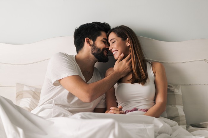 Ilustrasi pasangan suami istri Affectionate young couple relaxing in bed and having a romantic moment