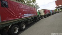 Pekerja memasang spanduk di atas truk kontainer berisi komoditas ekspor saat menunggu pelepasan konvoi Ekspor oleh Menteri Perdagangan di Jogja Expo Center, Yogyakarta, Jumat (16/10/2020).