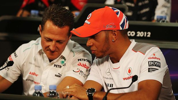 MONTE CARLO, MONACO - MAY 23:  Lewis Hamilton (R) of Great Britain and McLaren talks with Michael Schumacher (L) of Germany and Mercedes GP at the drivers press conference during previews to the Monaco Formula One Grand Prix at the Monte Carlo Circuit on May 23, 2012 in Monte Carlo, Monaco.  (Photo by Clive Mason/Getty Images)