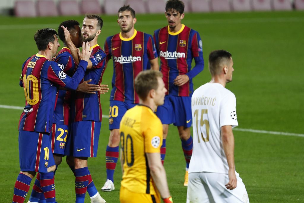 Barcelona vs Ferencvaros Barcelona players celebrate the second goal of their team during the Champions League group G soccer match between FC Barcelona and Ferencvaros at the Camp Nou stadium in Barcelona, Spain, Tuesday, Oct. 20, 2020. (AP Photo/Joan Monfort)