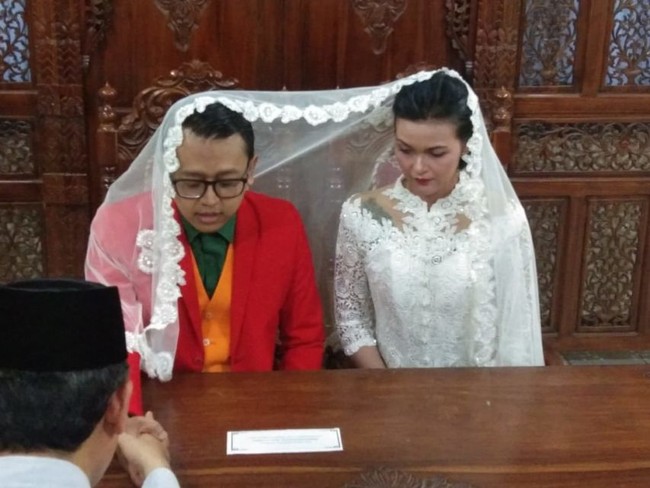 Biar anti mainstream, pengantin yang satu ini pakai jas ala Joker. Untung wajahnya nggak dimakeup ala Joker juga ya.. Foto: Twitter/Beruang1189