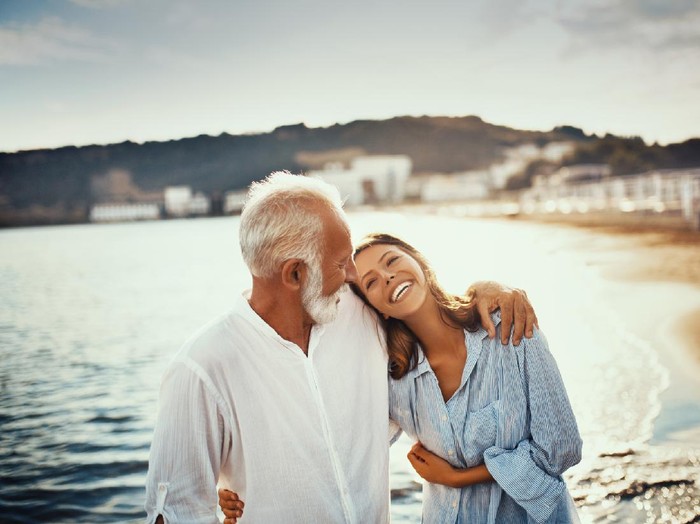 653963922 Man holding hands of woman in restaurant
