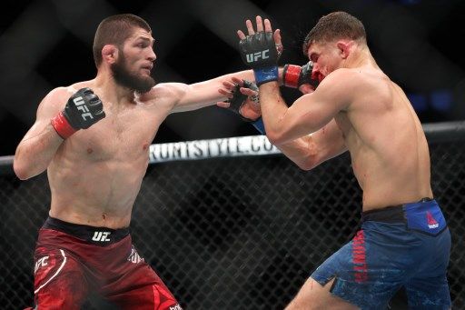 NEW YORK, NY - APRIL 07: Khabib Nurmagomedov (L) lands a left hand on the head of Al Iaquinta (R) during their fight for the UFC lightweight championship at UFC 223 at Barclays Center on April 7, 2018 in New York City.  Ed Mulholland / Getty Images / AFP