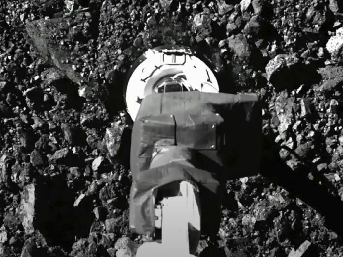 In this image taken from video released by NASA, the Osiris-Rex spacecraft touches the surface of asteroid Bennu on Tuesday, Oct. 20, 2020. (NASA via AP)
