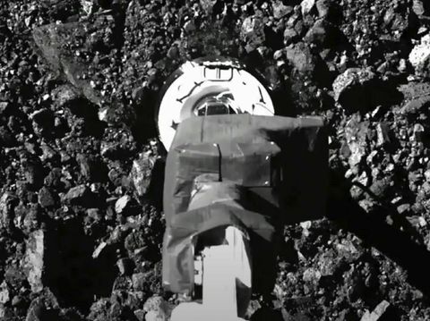 In this image taken from video released by NASA, the Osiris-Rex spacecraft touches the surface of asteroid Bennu on Tuesday, Oct. 20, 2020. (NASA via AP)