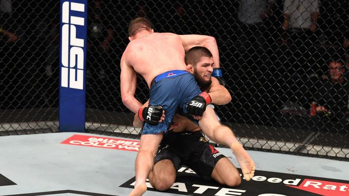 ABU DHABI, UNITED ARAB EMIRATES - OCTOBER 25:  In this handout image provided by UFC, (R-L) Khabib Nurmagomedov of Russia takes down Justin Gaethje in their lightweight title bout during the UFC 254 event on October 25, 2020 on UFC Fight Island, Abu Dhabi, United Arab Emirates. (Photo by Josh Hedges/Zuffa LLC via Getty Images)