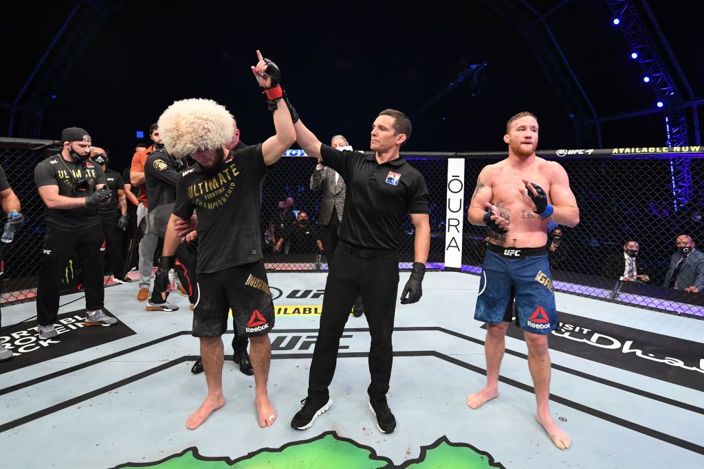 ABU DHABI, UNITED ARAB EMIRATES - OCTOBER 25: In this handout image provided by UFC, (L-R) Khabib Nurmagomedov of Russia celebrates his victory over Justin Gaethje in their lightweight title bout during the UFC 254 event on October 25, 2020 on UFC Fight Island, Abu Dhabi, United Arab Emirates. (Photo by Josh Hedges/Zuffa LLC via Getty Images)