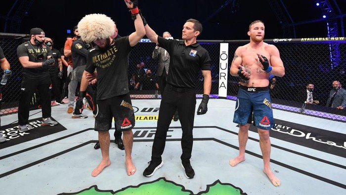 Khabib Nurmagomedov ABU DHABI, UNITED ARAB EMIRATES - OCTOBER 25: In this handout image provided by UFC, (L-R) Khabib Nurmagomedov of Russia celebrates his victory over Justin Gaethje in their lightweight title bout during the UFC 254 event on October 25, 2020 on UFC Fight Island, Abu Dhabi, United Arab Emirates. (Photo by Josh Hedges/Zuffa LLC via Getty Images)
