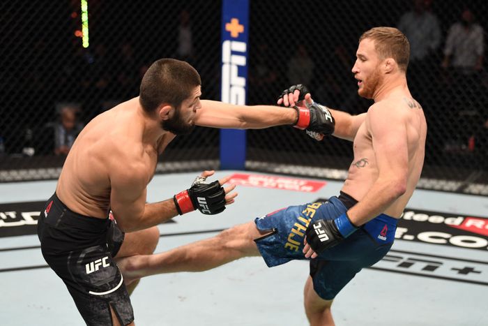 Khabib Nurmagomedov vs Justin Gaethje ABU DHABI, UNITED ARAB EMIRATES - OCTOBER 25: In this handout image provided by UFC, (R-L) Justin Gaethje kicks Khabib Nurmagomedov of Russia in their lightweight title bout during the UFC 254 event on October 25, 2020 on UFC Fight Island, Abu Dhabi, United Arab Emirates. (Photo by Josh Hedges/Zuffa LLC via Getty Images)