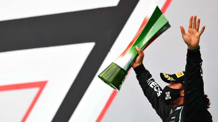 PORTIMAO, PORTUGAL - OCTOBER 25: Race winner Lewis Hamilton of Great Britain and Mercedes GP celebrates his record breaking 92nd race win on the podium during the F1 Grand Prix of Portugal at Autodromo Internacional do Algarve on October 25, 2020 in Portimao, Portugal. (Photo by Mark Thompson/Getty Images)