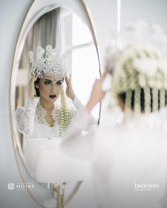Adapun siger yang memahkotai kepala Vicy Melanie dirancang oleh desainer aksesori kenamaan Rinaldy A. Yunardi. (Foto: Moire Photo/ Bridestory/ Dok. Instagram)