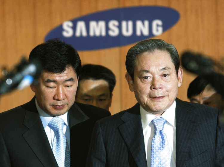 FILE - In this July 6, 2011, file photo, Samsung Chairman Lee Kun-hee, right, greets people from the South Korean delegation in Durban, South Africa, for the 123rd International Olympic Committee (IOC) session that will decide the host city for the 2018 Olympics Winter Games. Lee, the ailing Samsung Electronics chairman who transformed the small television maker into a global giant of consumer electronics, has died, a Samsung statement said Sunday, Oct. 25, 2020. He was 78. (AP Photo/Schalk van Zuydam, File)