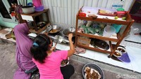 Relawan membuat makan siang untuk diserahkan kepada warga yang dikarantina mandiri.