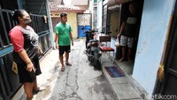 Relawan membagikan makanan kepada warga yang dikarantina mandiri di kampung Gabudan, Pasar Kliwon, Solo, Jawa Tengah, Minggu (25/10). 
