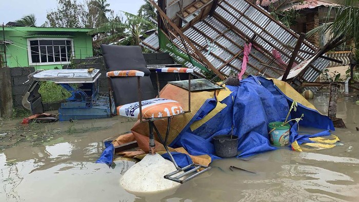 The remains of a barbershop is surrounded by floods in Pola town on the island of Mindoro, central Philippines, Monday, Oct. 26, 2020. A fast-moving typhoon forced thousands of villagers to flee to safety in provinces south of the Philippine capital Monday, flooding rural villages and ripping off roofs, officials said. (AP Photo/Erik De Castro)