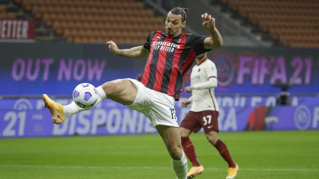 AC Milan's Zlatan Ibrahimovic scores his side's opening goal during the Serie A soccer match between AC Milan and Roma at the Milan San Siro Stadium, Italy, Monday, Oct. 26, 2020. (AP Photo/Luca Bruno)