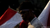 Selain mengibarkan bendera, pendemo ini juga memakai ikat kepala merah putih.