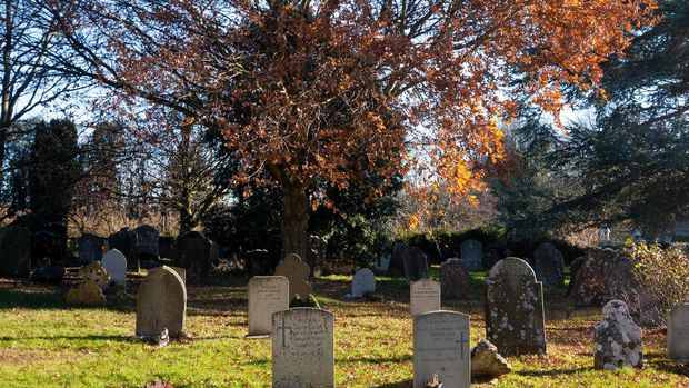 St Nicholas Church Graveyard in Pluckley, England, with several names and dates visible on the tombstones