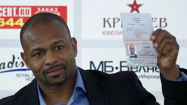 FILE - In this Oct. 28, 2015, file photo, former world boxing champion Roy Jones Jr. shows off his Russian passport during a news conference in Moscow, Russia. Mike Tyson and Jones got permission from California's athletic commission to return to the boxing ring next month because their fight would be strictly an exhibition of their once-unparalleled skills. (AP Photo/Ivan Sekretarev, File)