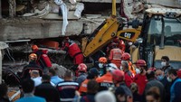 Tim SAR berjibaku mencari korban di reruntuhan gedung. Burak Kara/Getty Images.