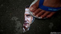 Foto Presiden Prancis Emmanuel Macron pun tampak diinjak oleh salah satu demonstran.