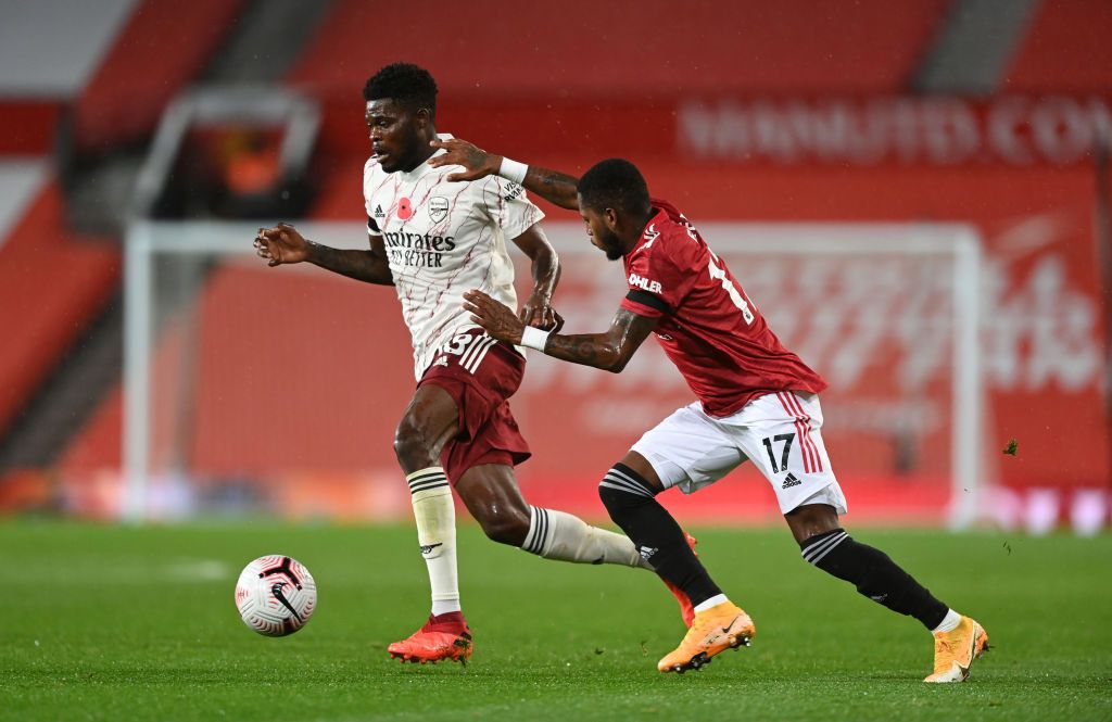 Thomas Partey MANCHESTER, ENGLAND - NOVEMBER 01: Thomas Partey of Arsenal is put under pressure by Paul Pogba of Manchester United during the Premier League match between Manchester United and Arsenal at Old Trafford on November 01, 2020 in Manchester, England. Sporting stadiums around the UK remain under strict restrictions due to the Coronavirus Pandemic as Government social distancing laws prohibit fans inside venues resulting in games being played behind closed doors. (Photo by Shaun Botterill/Getty Images)